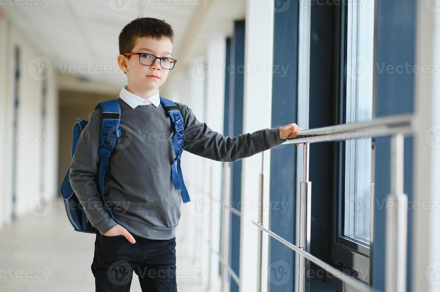 Portrait of cute school boy with backpack. Schoolboy with a backpack at school. Back to school photo