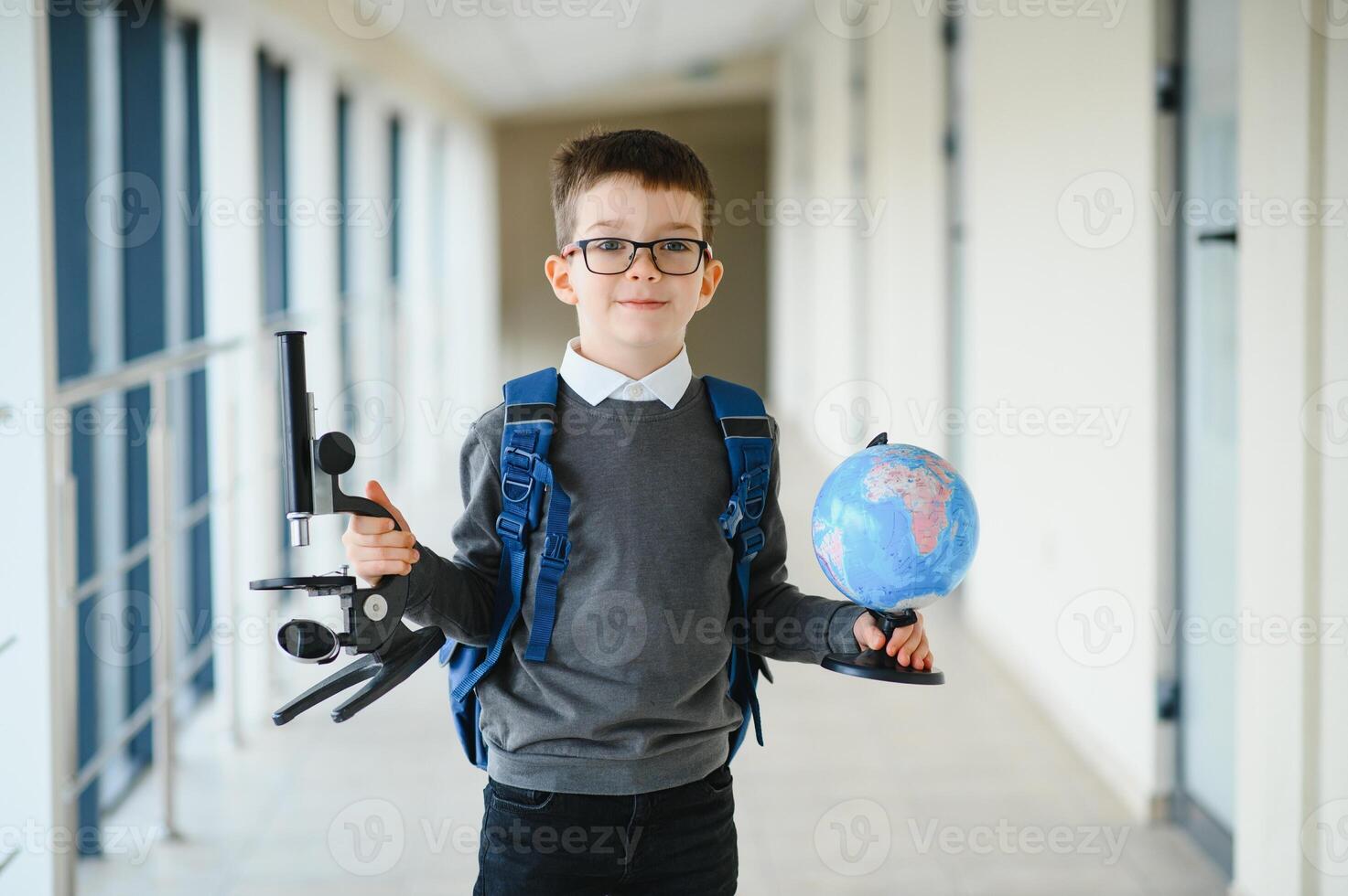 Cheerful smiling little boy with big backpack having fun. School concept. Back to School. photo