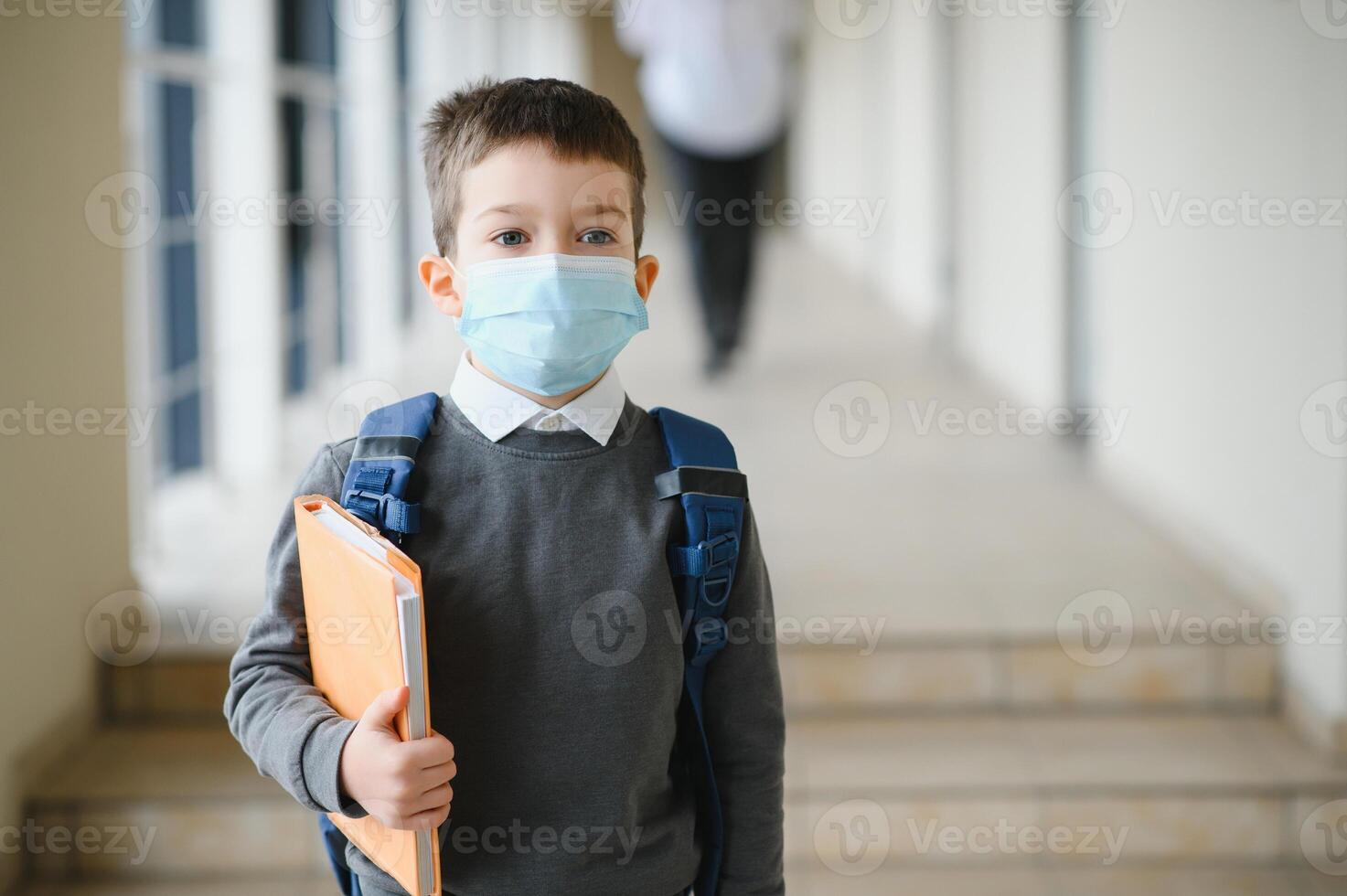 Little schoolboy wearing a mask during an outbreak of corona and influenza virus, protection against diseases for children, Mask for the prevention of coronavirus. photo