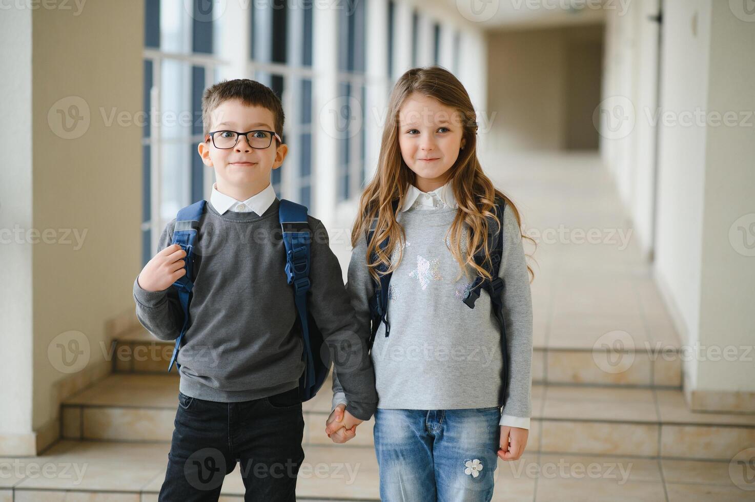 Happy school kids in corridor at school photo