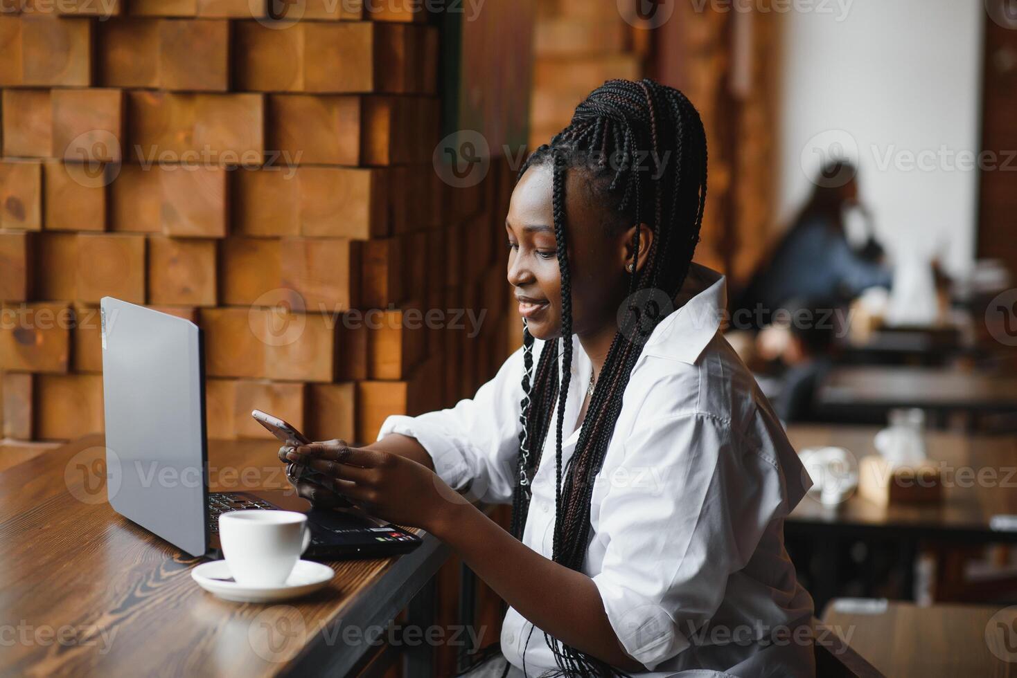 Happy african american woman worker using laptop work study at computer in loft office or cafe, smiling mixed race female student freelancer using pc app dating communicating online watching webinar photo