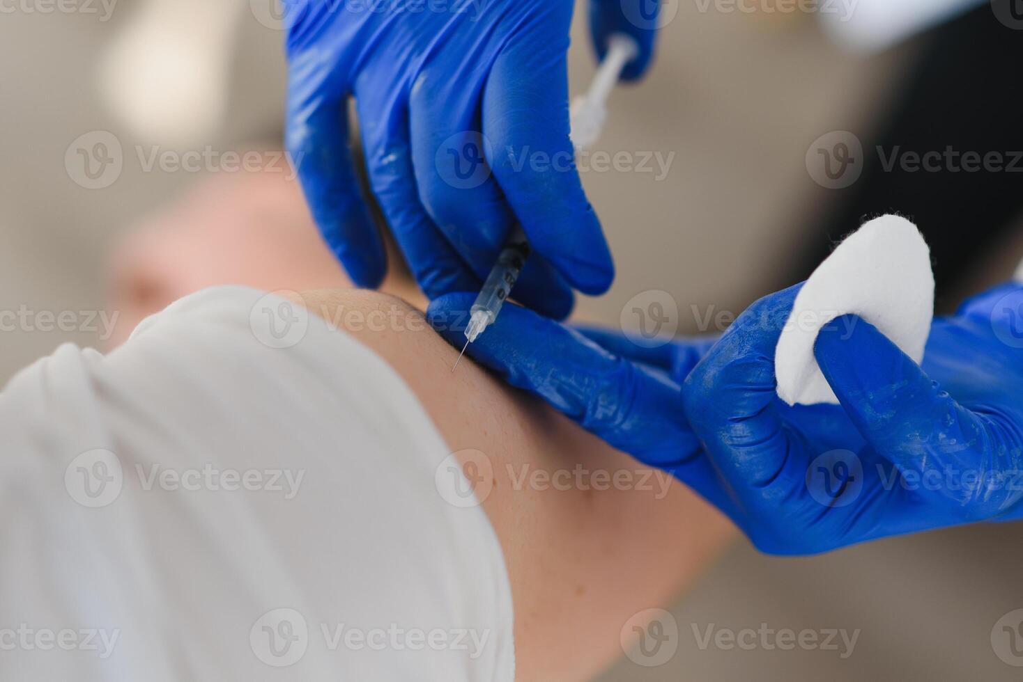 Close up of a Doctor making a vaccination in the shoulder of patient, Flu Vaccination Injection on Arm, coronavirus, covid-19 vaccine disease preparing for human clinical trials vaccination shot photo