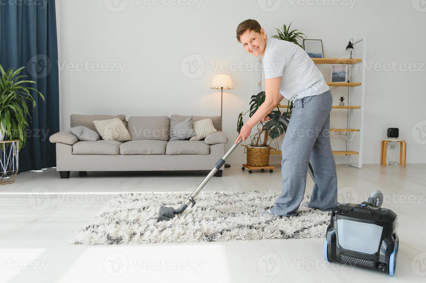 Woman with accumulator vacuum cleaner. photo