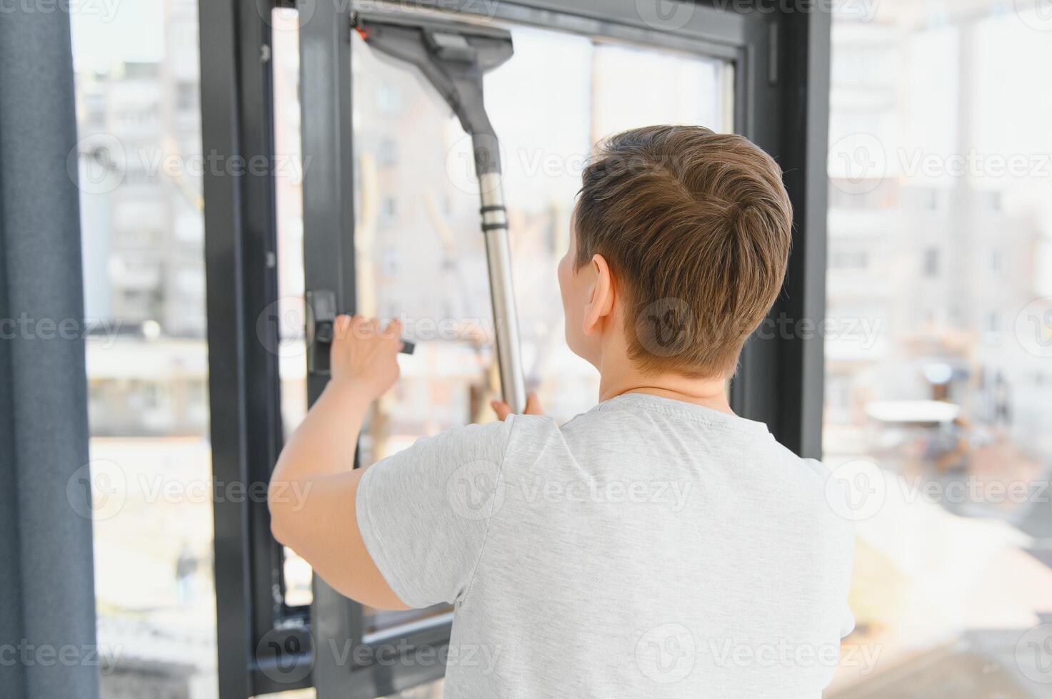 beautiful senior woman cleaning window glass. photo