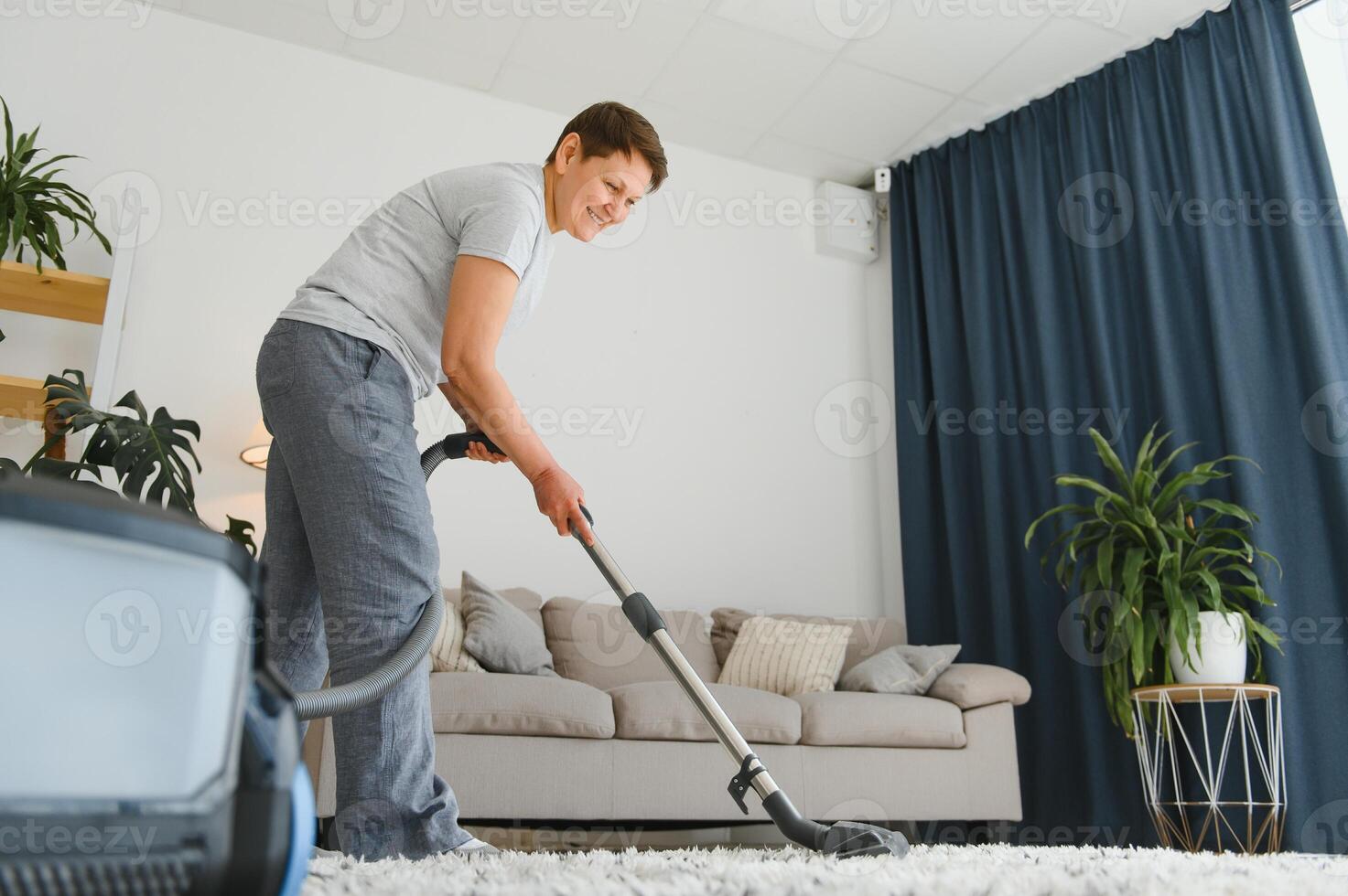 Middle-aged woman cleaning new apartment. photo