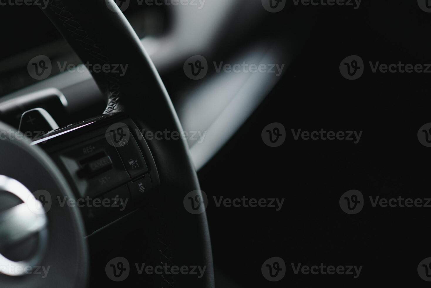 Luxury car interior. Steering wheel, shift lever and dashboard. photo