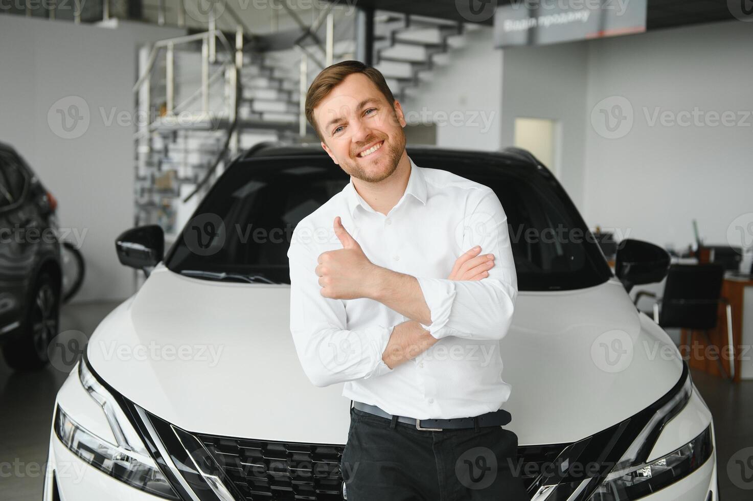 Man adult customer male buyer client chooses auto wants to buy new automobile touch check car in showroom vehicle salon dealership store motor show indoor. Sales concept photo