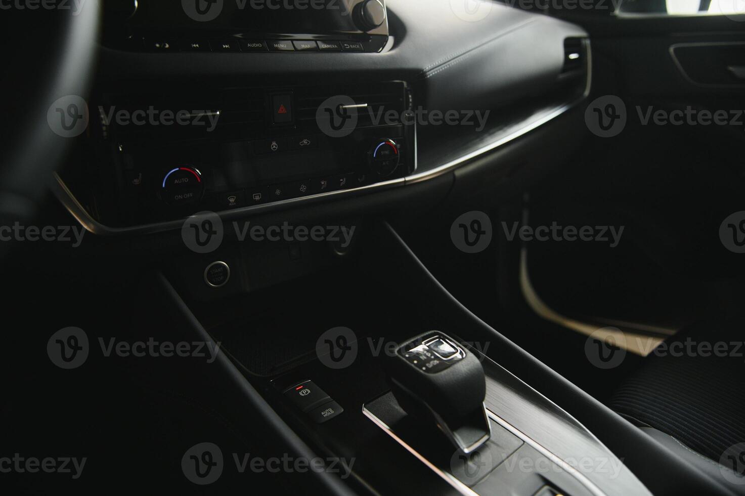 Luxury car interior. Steering wheel, shift lever and dashboard. photo