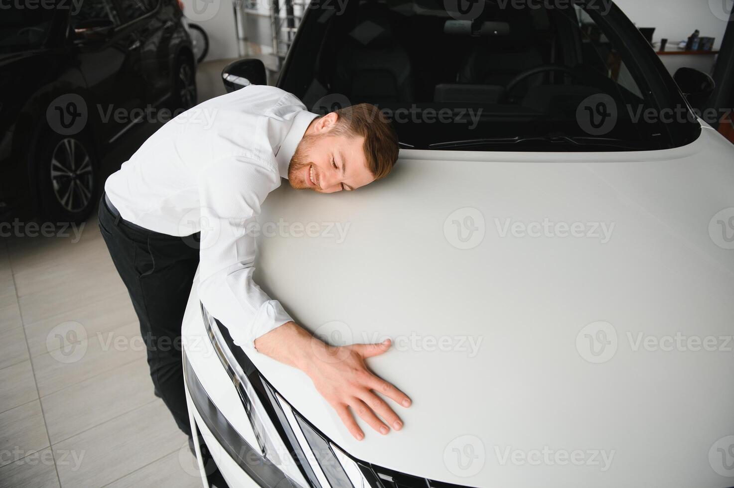Man adult customer male buyer client chooses auto wants to buy new automobile touch check car in showroom vehicle salon dealership store motor show indoor. Sales concept photo