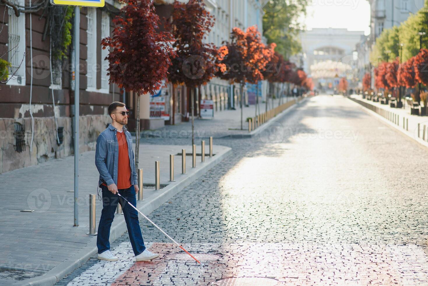 Blind man. People with disability, handicapped person and everyday life. Visually impaired man with walking stick. photo