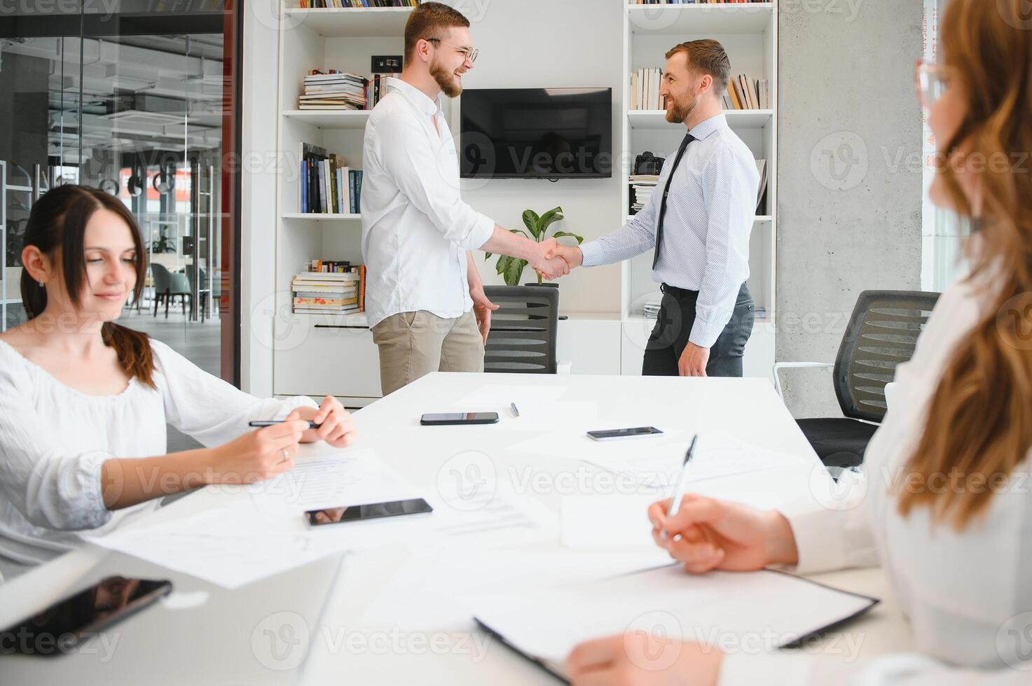 Corporate business team and manager in a meeting room at modern office with panoramic windows. Business concept photo