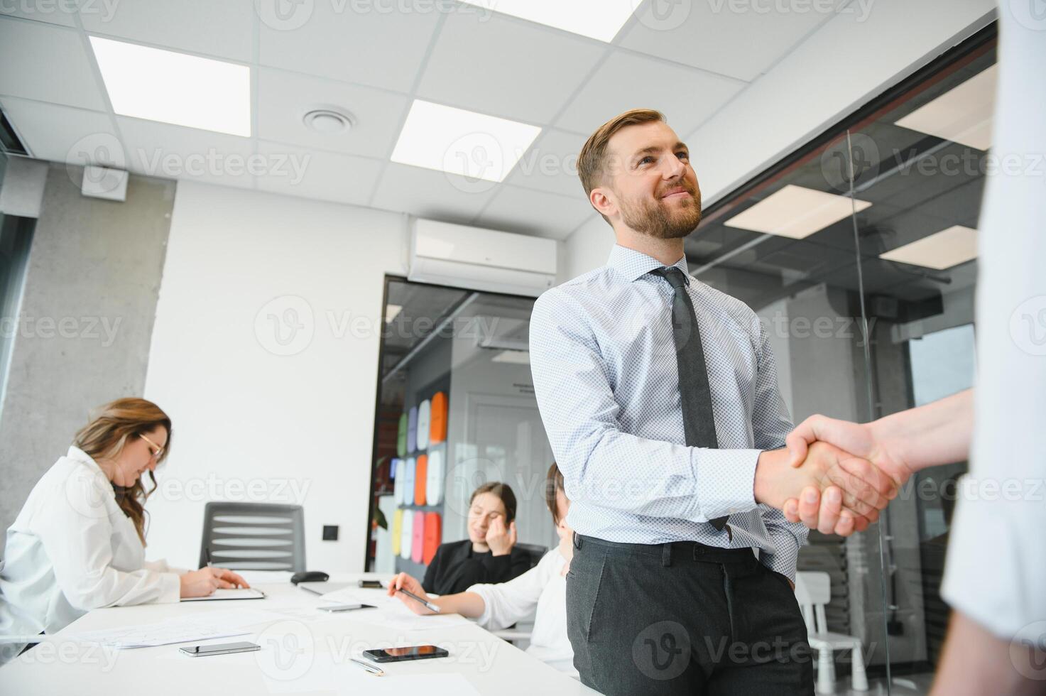 Confident and successful team. Group of people are working together in office. Blurred background photo