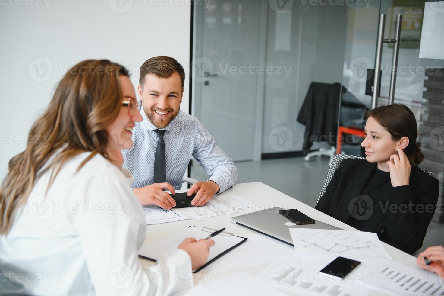 Confident and successful team. Group of people are working together in office. Blurred background photo