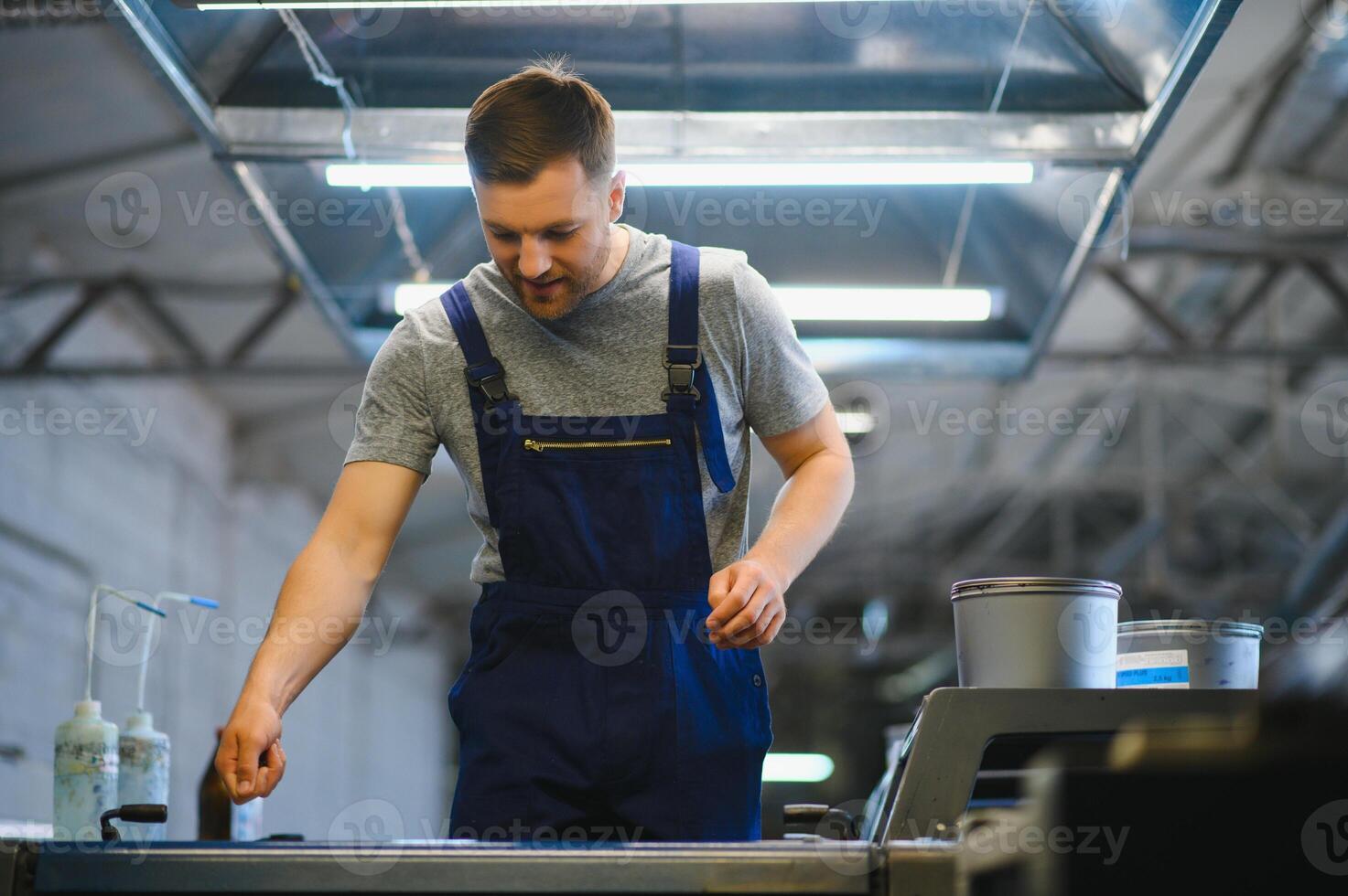worker in factory on the machine photo