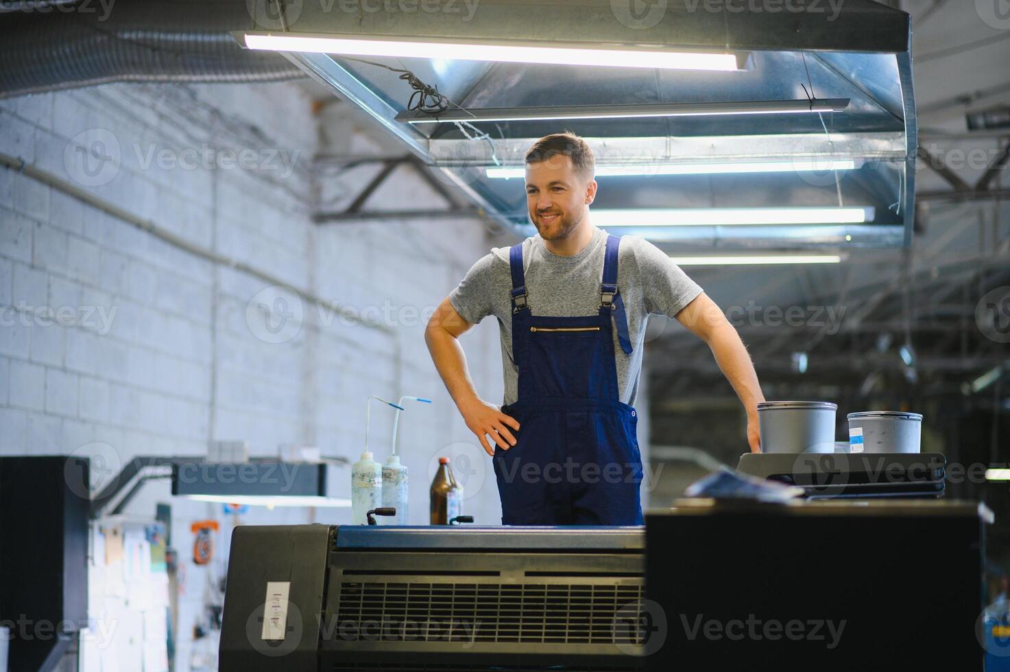 Funny portrait of typographer standing with color swatches at the printing manufacturing photo