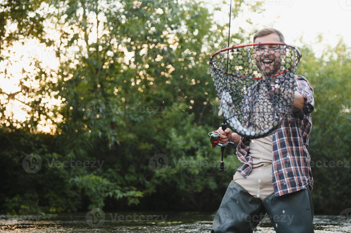 Fishing. Fisherman and trout. Fisherman on wild river. photo