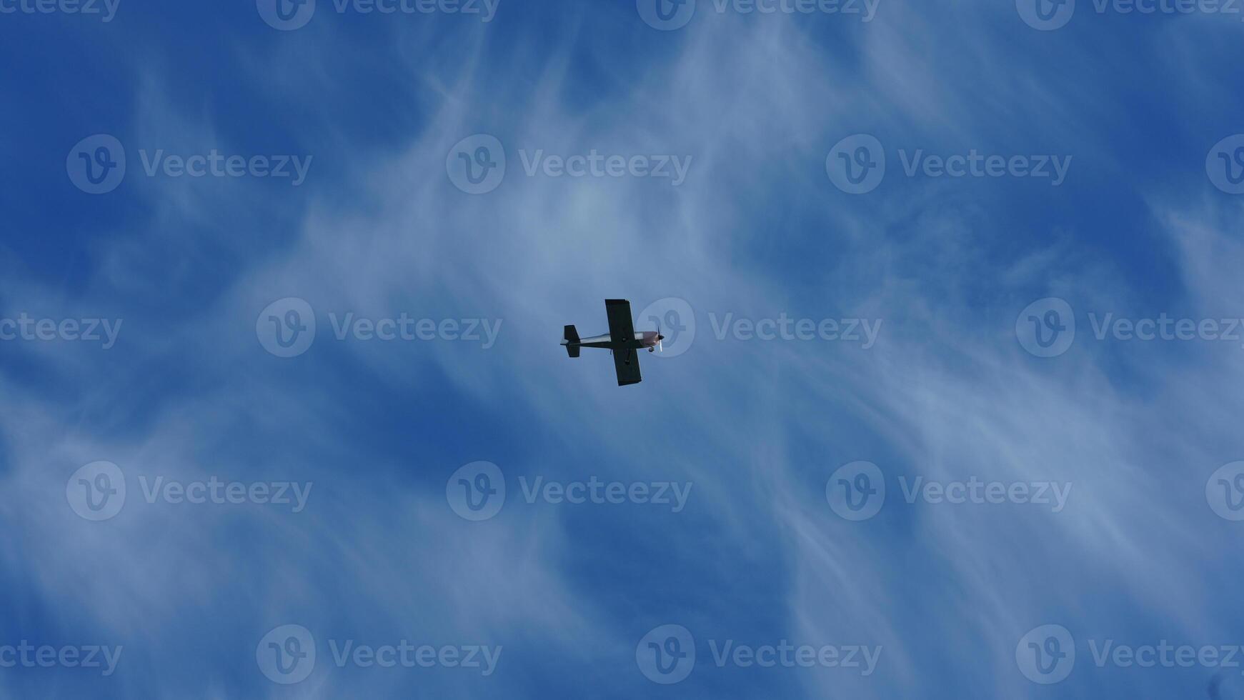 One plane flying over in the blue sky in autumn photo
