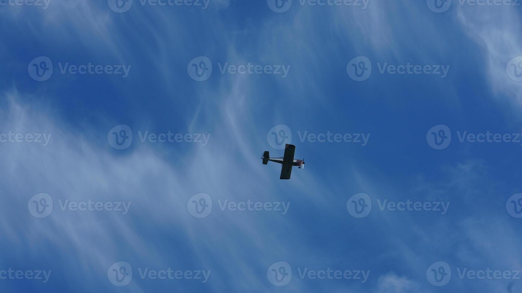 One plane flying over in the blue sky in autumn photo