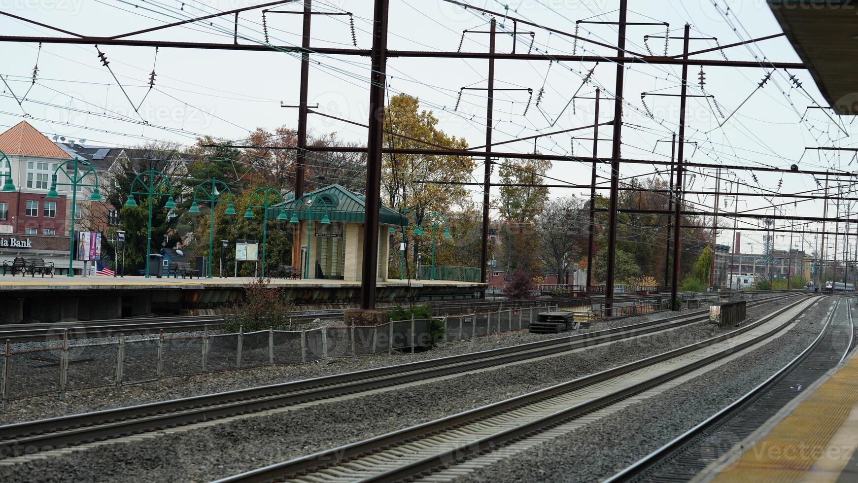 The train station view with the iron tracks near the platform photo