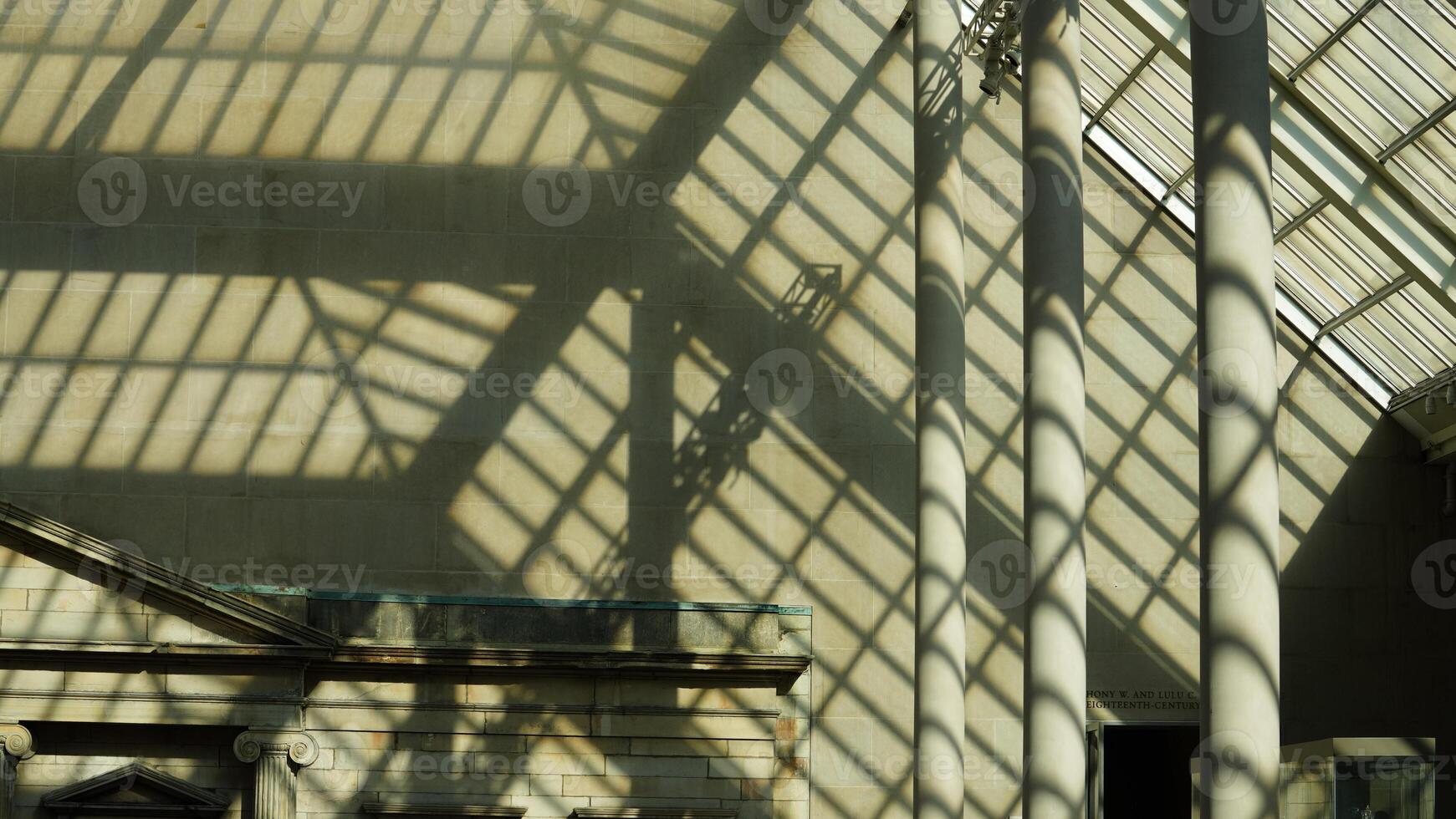 The museum interior view with the transparent glass wall in the sunny day photo