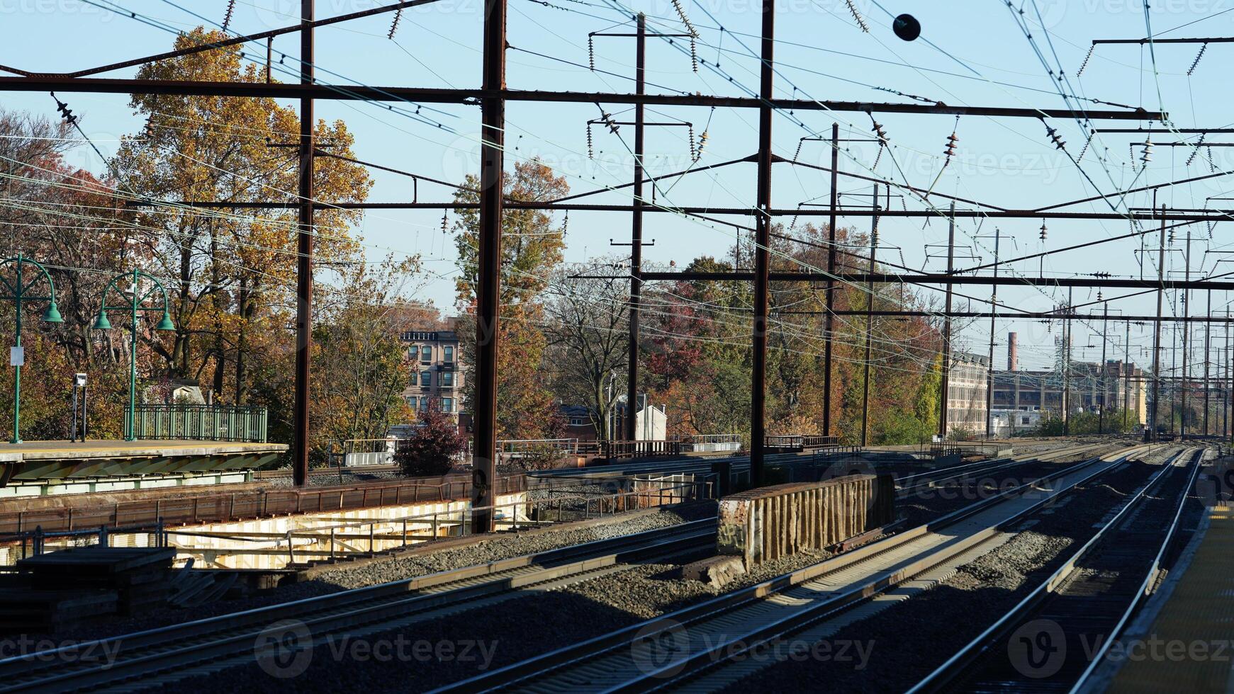 The train station view with the iron tracks near the platform photo