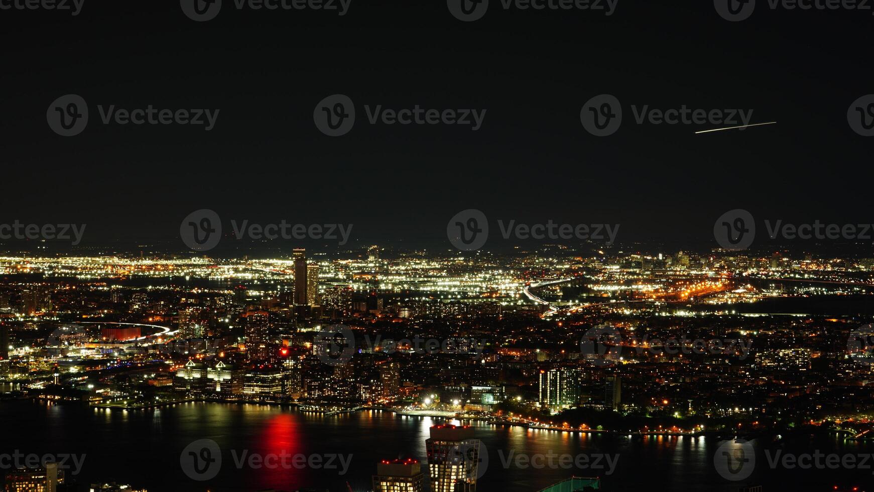 The New York city night view with the lights on in the skyscrapers at night photo