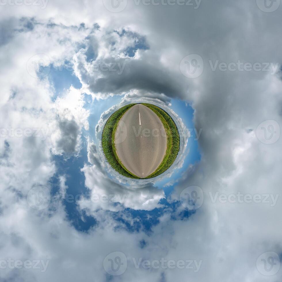 simple little tiny planet without buildings in blue sky with beautiful clouds. Transformation of spherical panorama 360 degrees. Spherical abstract aerial view. Curvature of space. photo