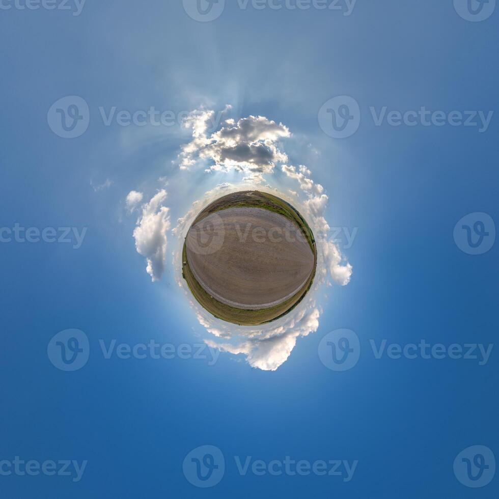 simple little tiny planet without buildings in blue sky with beautiful clouds. Transformation of spherical panorama 360 degrees. Spherical abstract aerial view. Curvature of space. photo
