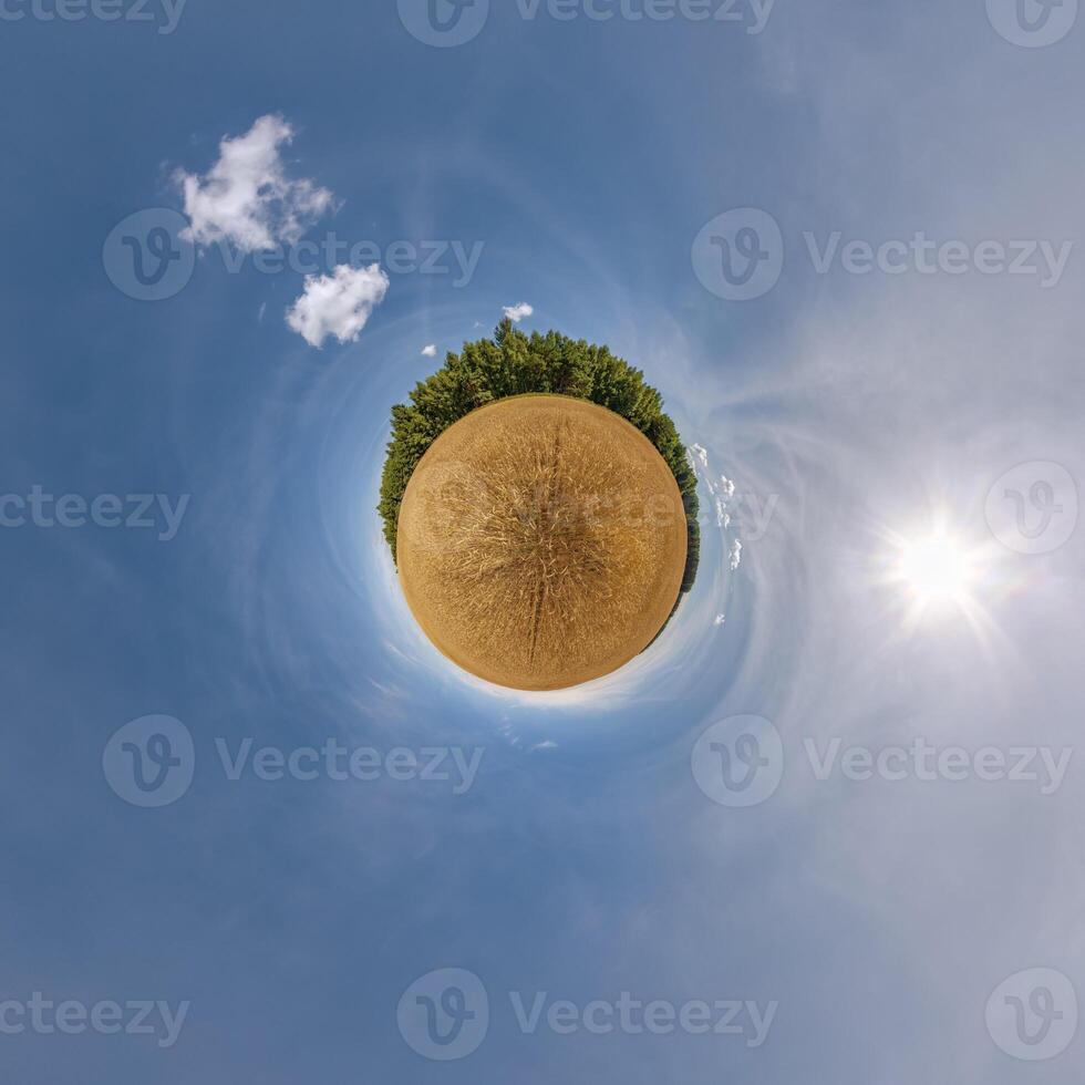 simple little tiny planet without buildings in blue sky with beautiful clouds. Transformation of spherical panorama 360 degrees. Spherical abstract aerial view. Curvature of space. photo