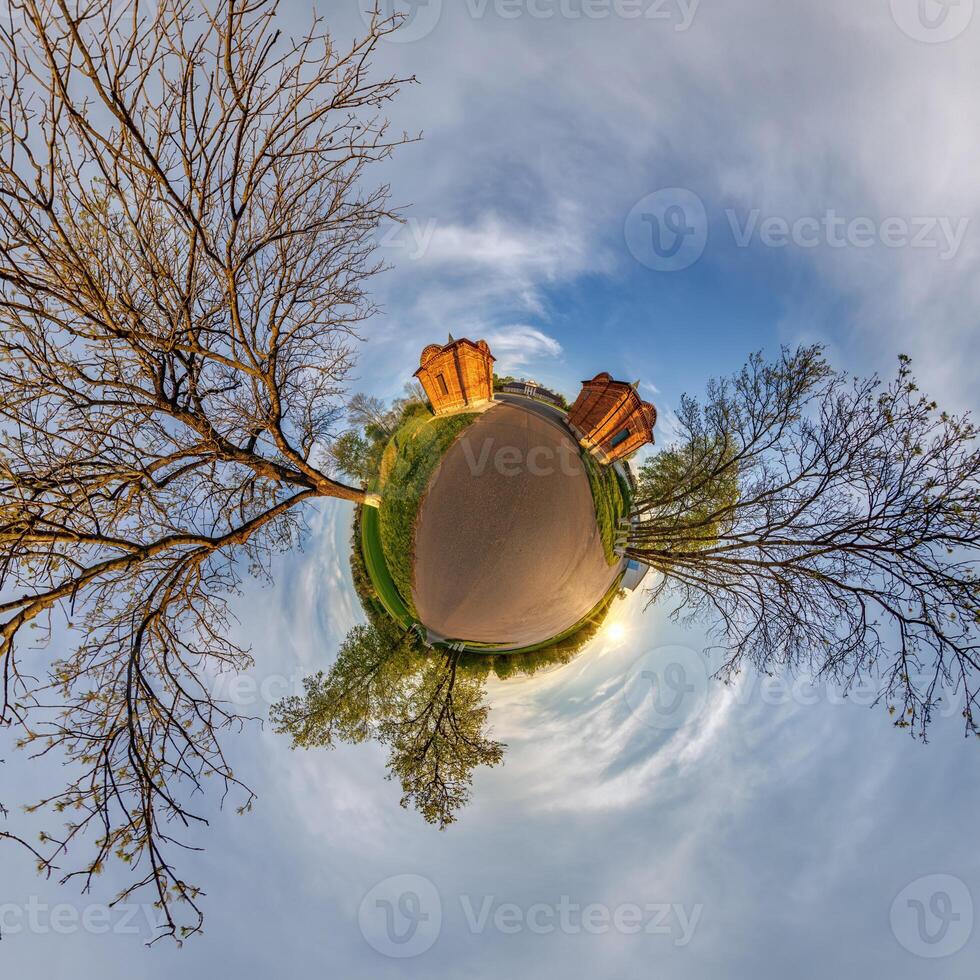tiny planet transformation of spherical panorama 360 degrees. Spherical abstract aerial view with trees in forest with clumsy branches in blue sky. Curvature of space. photo