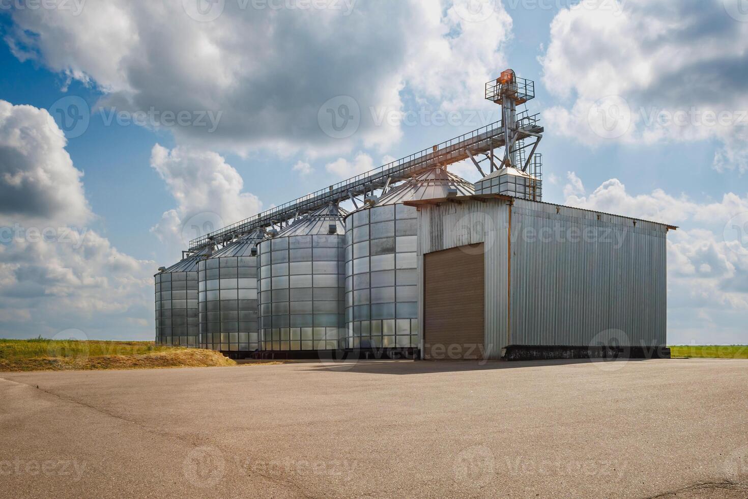 silos on agro-industrial complex with seed cleaning and drying line for grain storage. Granary elevator photo
