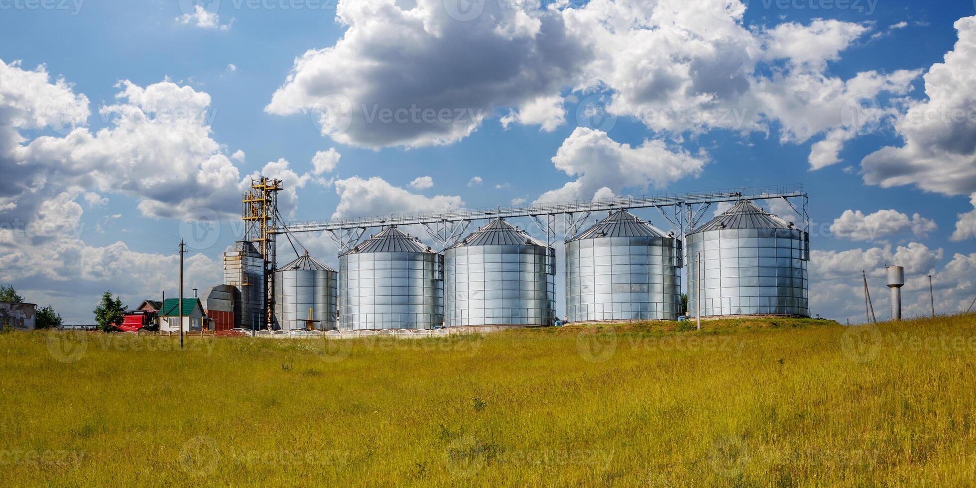 silos on agro-industrial complex with seed cleaning and drying line for grain storage. Granary elevator photo