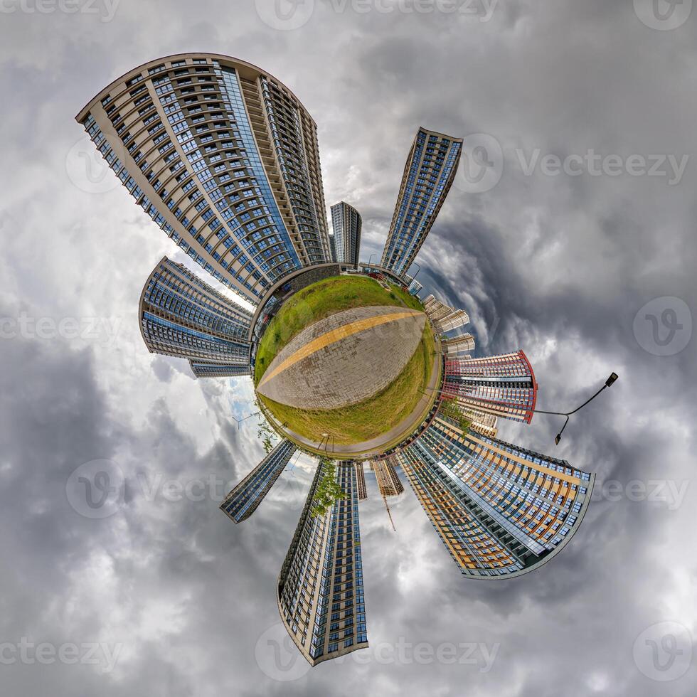 abstract swirling tiny planet spherical panorama of multi-storey buildings of skyscrapers of a residential complex in the form of a butterfly, bugs, crabs in sky with clouds photo