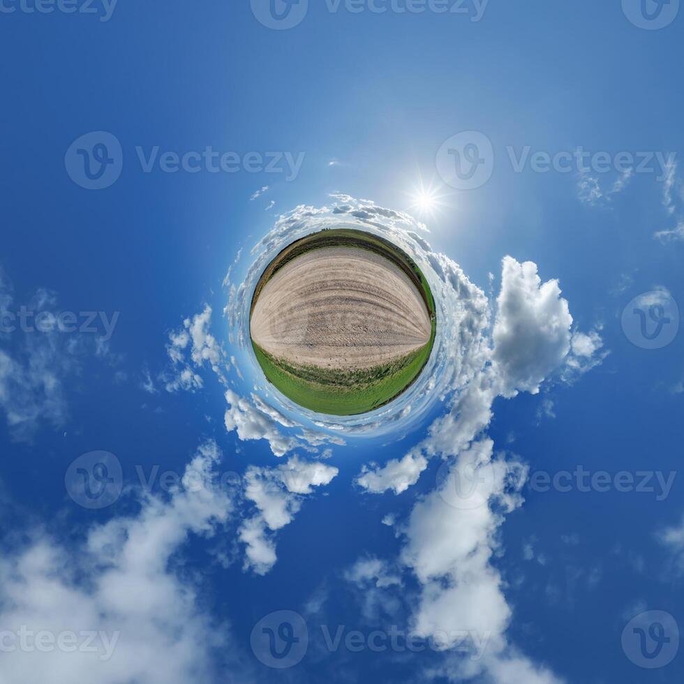 simple little tiny planet without buildings in blue sky with beautiful clouds. Transformation of spherical panorama 360 degrees. Spherical abstract aerial view. Curvature of space. photo