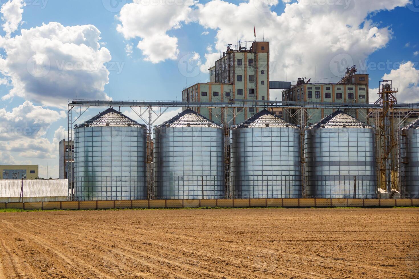 silos on agro-industrial complex with seed cleaning and drying line for grain storage. Granary elevator photo