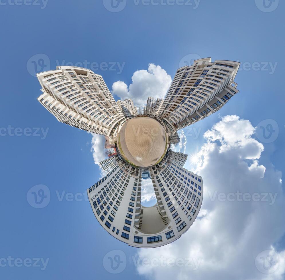 abstract swirling tiny planet spherical panorama of multi-storey buildings of skyscrapers of a residential complex in the form of a butterfly, bugs, crabs in sky with clouds photo