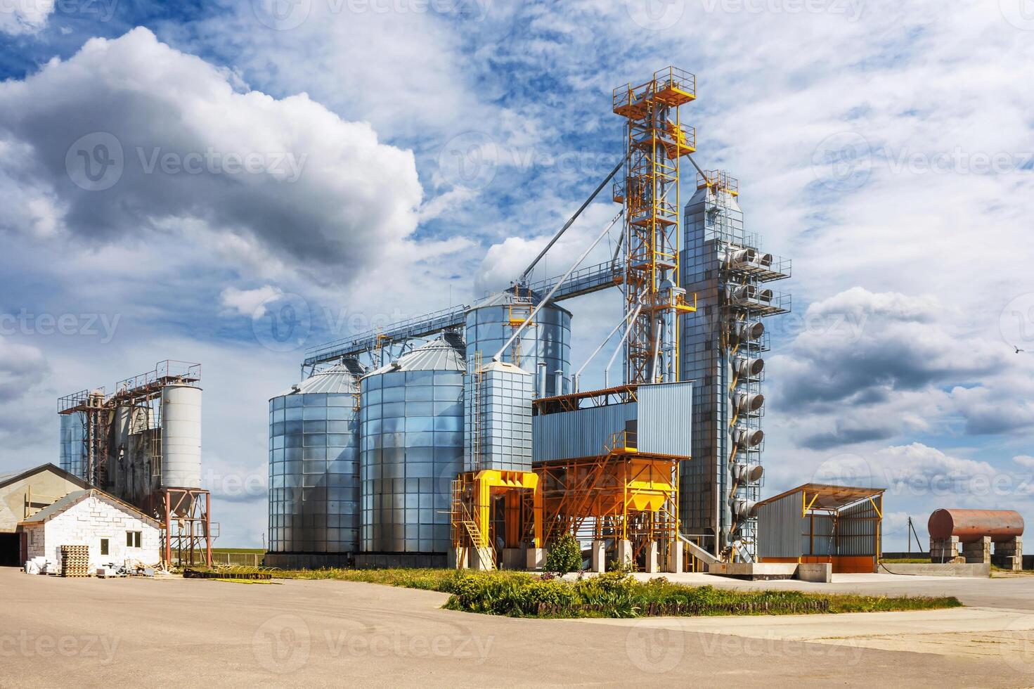 silos on agro-industrial complex with seed cleaning and drying line for grain storage. Granary elevator photo