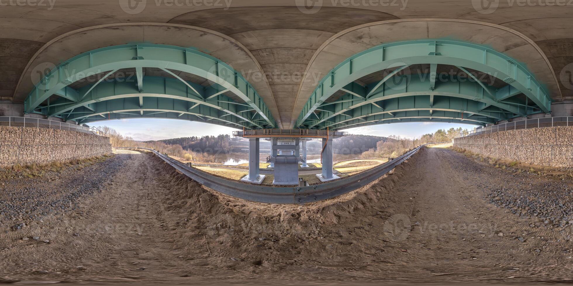 hdri 360 panorama on gravel road under steel frame construction of huge car bridge across river in equirectangular full seamless spherical projection. VR AR content photo