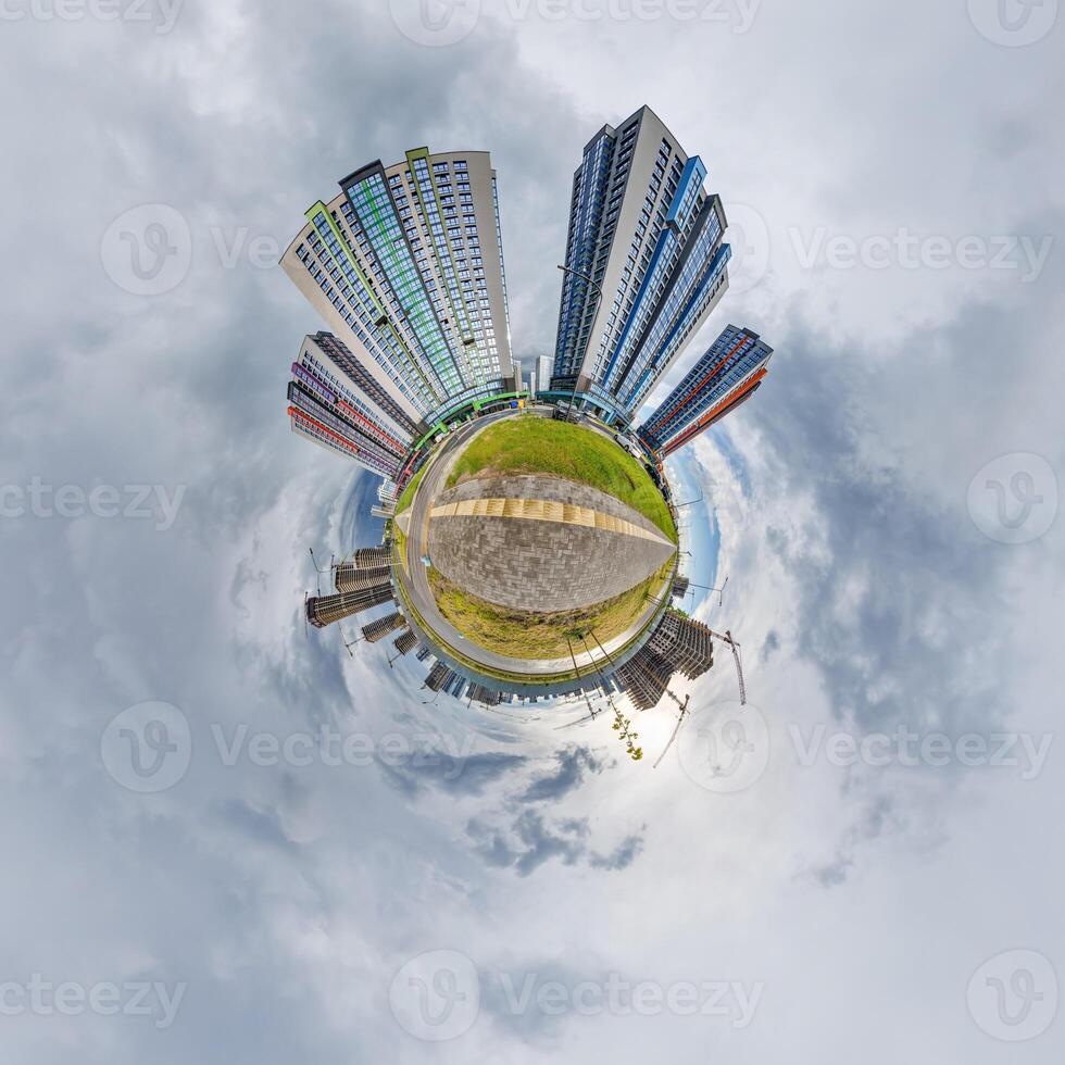 abstract swirling tiny planet spherical panorama of multi-storey buildings of skyscrapers of a residential complex in the form of a butterfly, bugs, crabs in sky with clouds photo