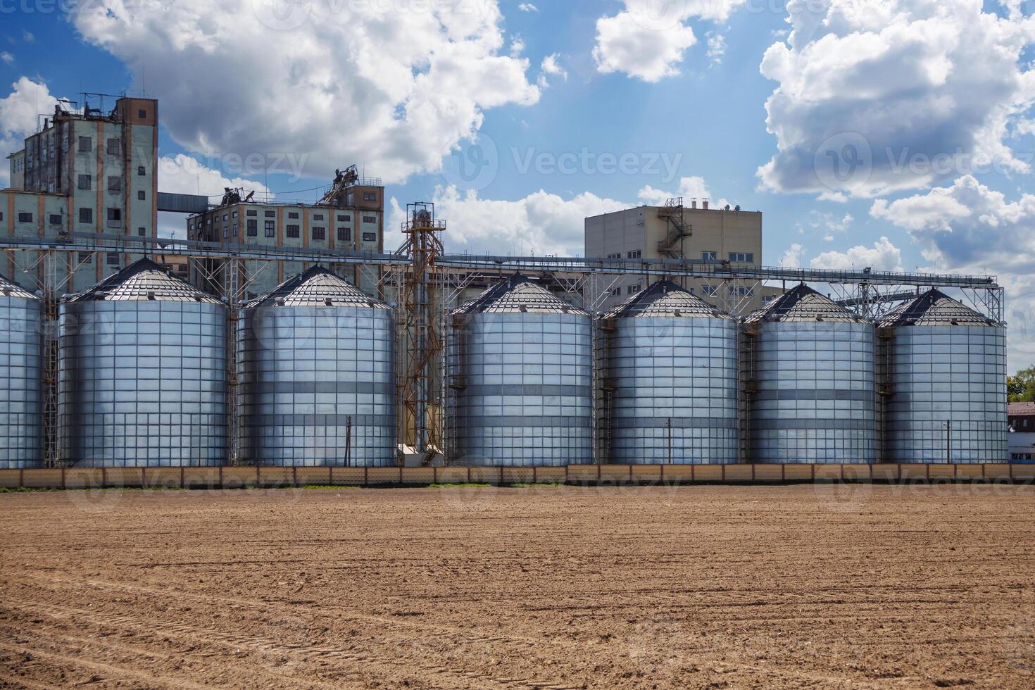 silos on agro-industrial complex with seed cleaning and drying line for grain storage. Granary elevator photo
