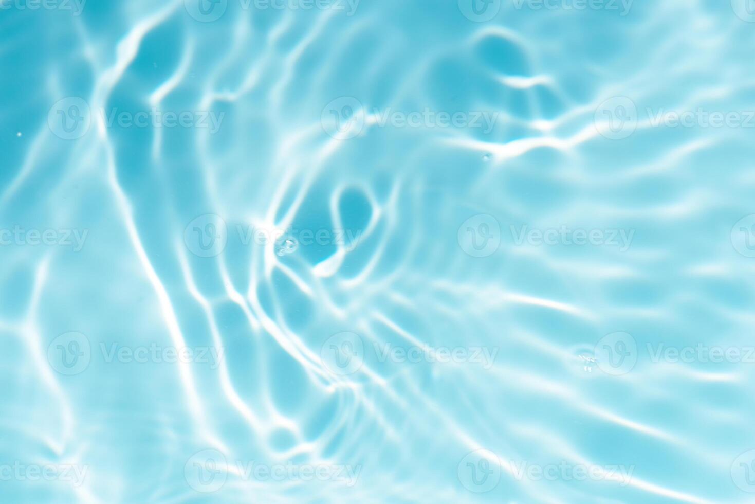 Blue water with ripples on the surface. Defocus blurred transparent blue colored clear calm water surface texture with splashes and bubbles. Water waves with shining pattern texture background. photo