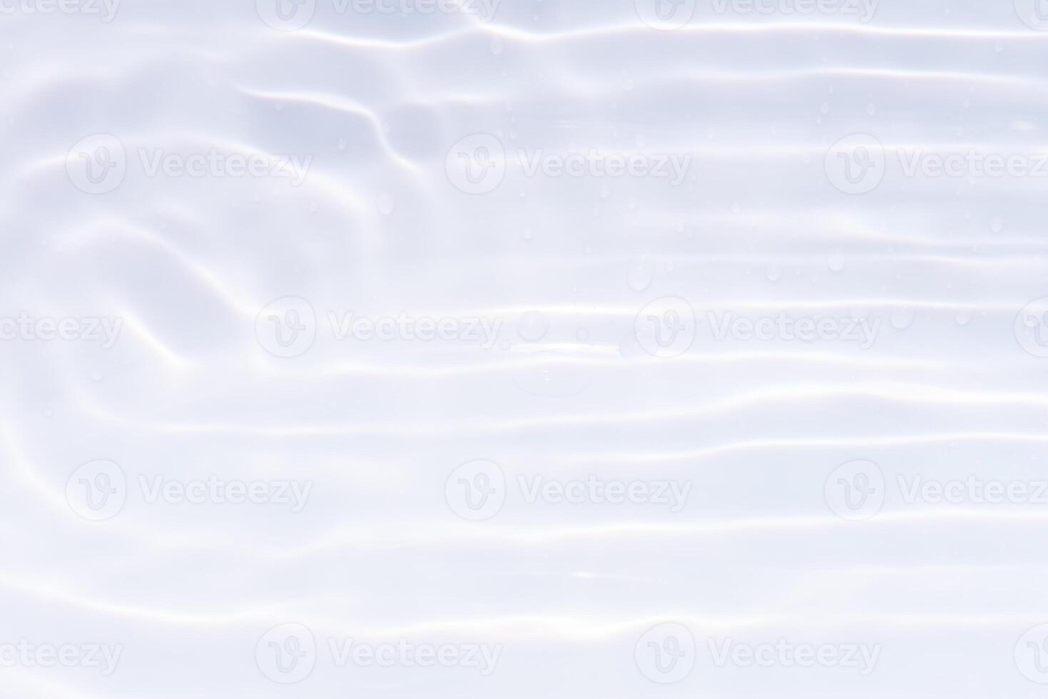 Blue water with ripples on the surface. Defocus blurred transparent blue colored clear calm water surface texture with splashes and bubbles. Water waves with shining pattern texture background. photo