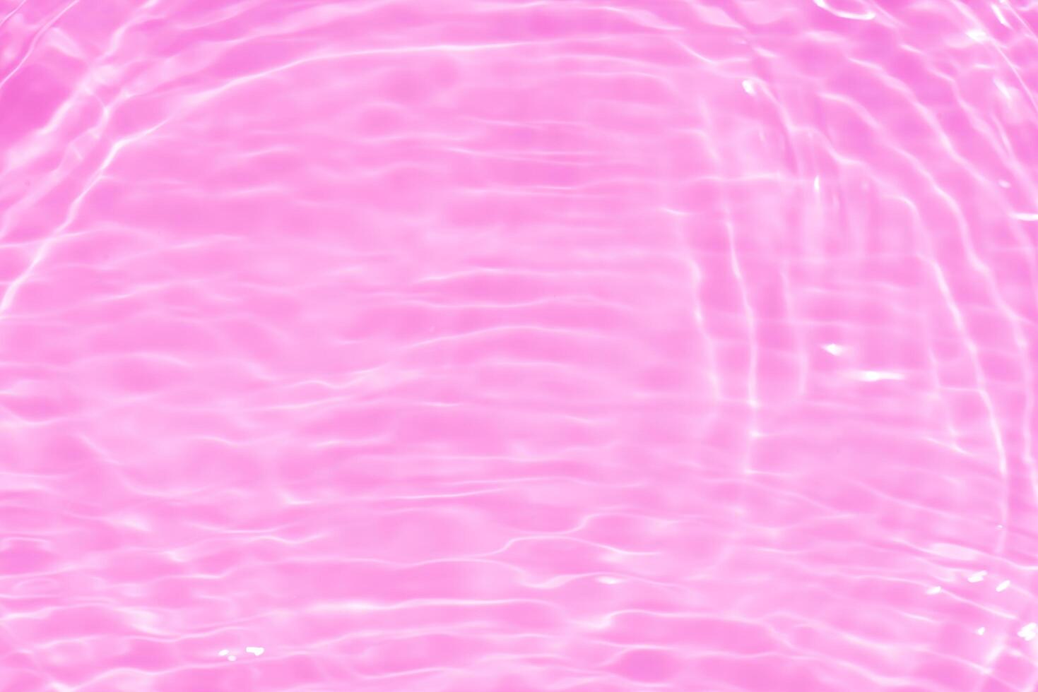 Blue water with ripples on the surface. Defocus blurred transparent blue colored clear calm water surface texture with splashes and bubbles. Water waves with shining pattern texture background. photo