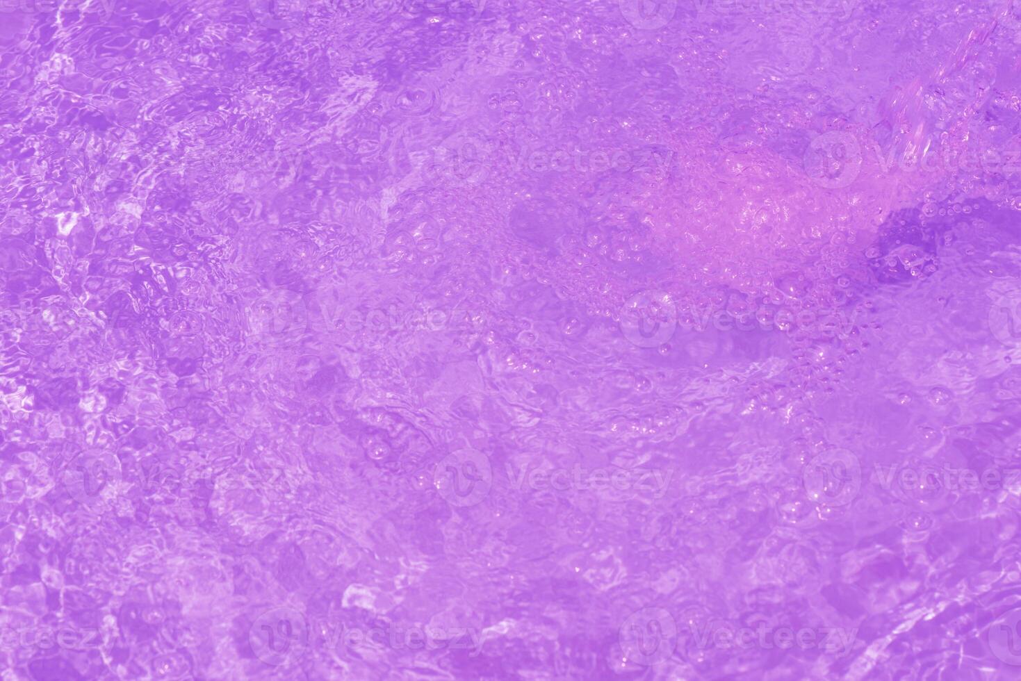 Blue water with ripples on the surface. Defocus blurred transparent blue colored clear calm water surface texture with splashes and bubbles. Water waves with shining pattern texture background. photo