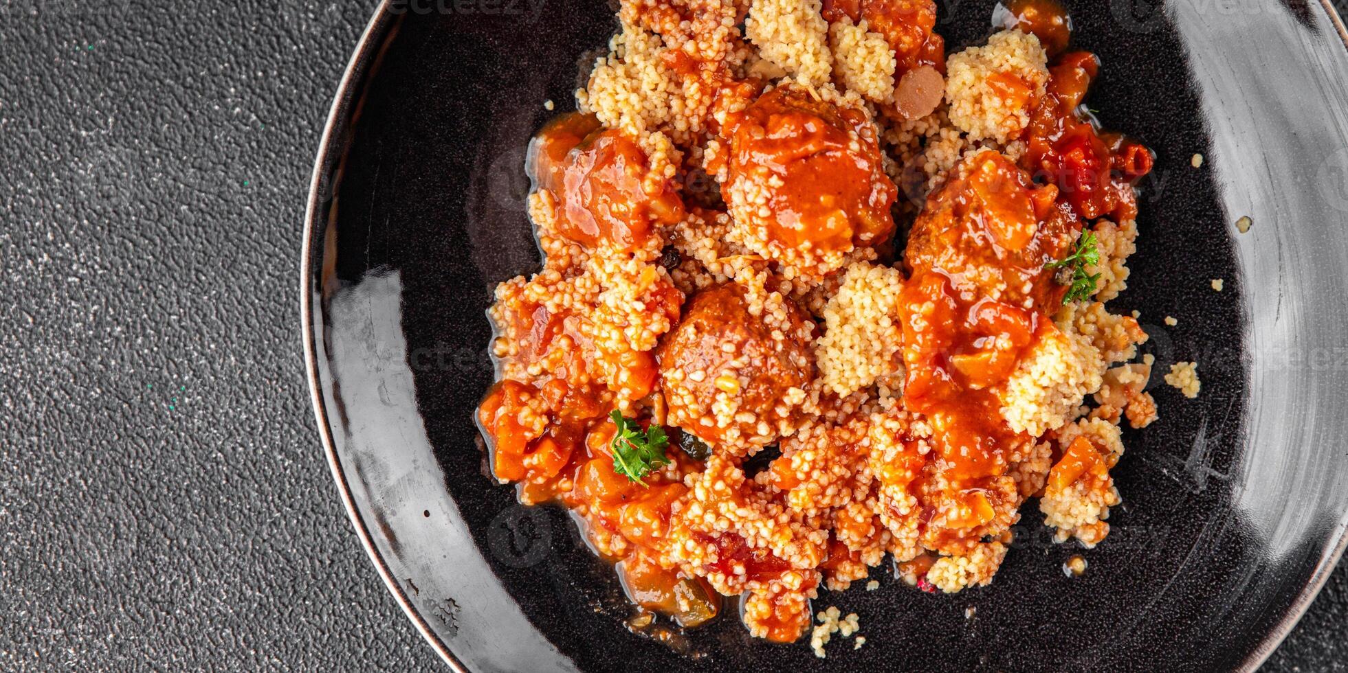 couscous with meat balls vegetable sauce tasty fresh meal food snack on the table copy space food background rustic top view keto or paleo diet photo