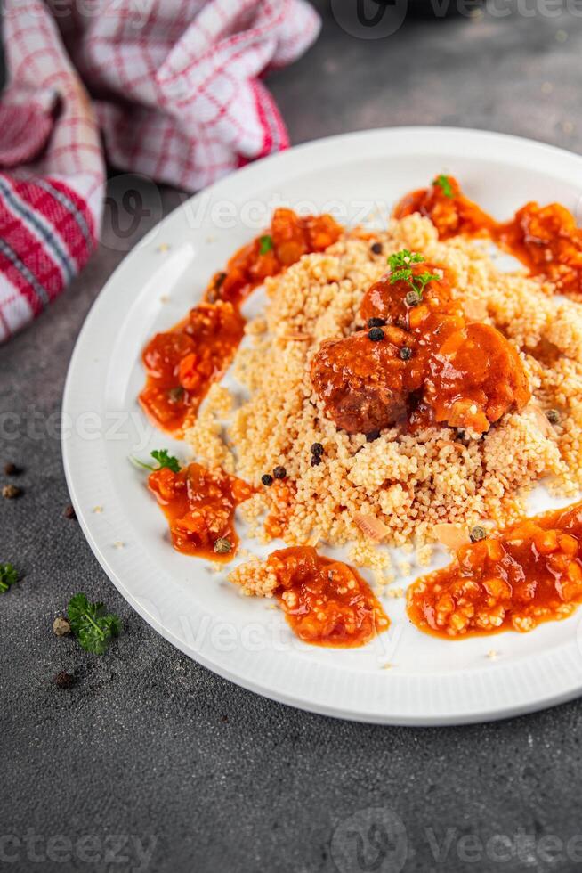 couscous with meat balls vegetable sauce tasty fresh meal food snack on the table copy space food background rustic top view keto or paleo diet photo
