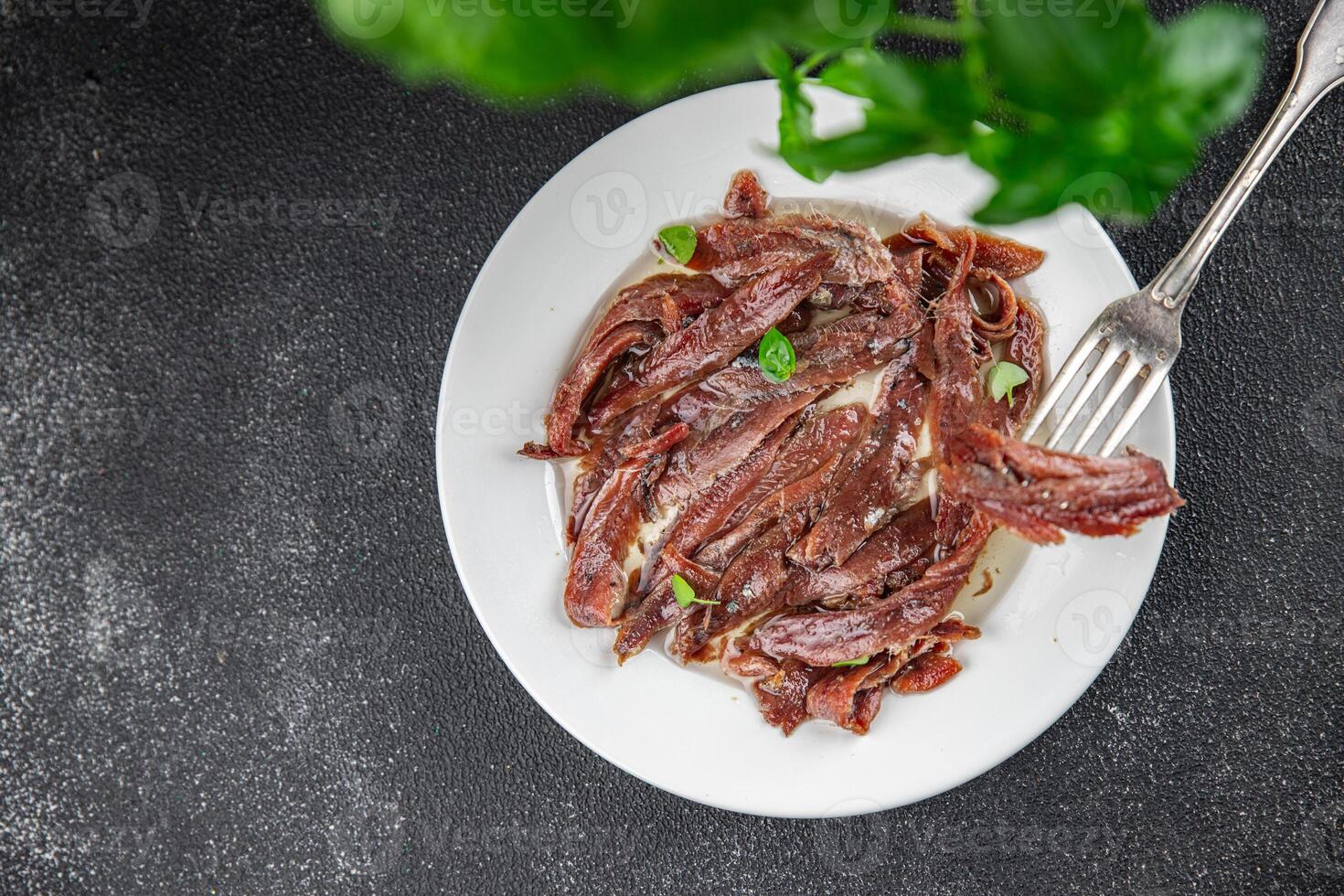 anchovies in a plate on the table canned fish in oil fresh and tasty seafood meal food snack on the table copy space food background rustic photo