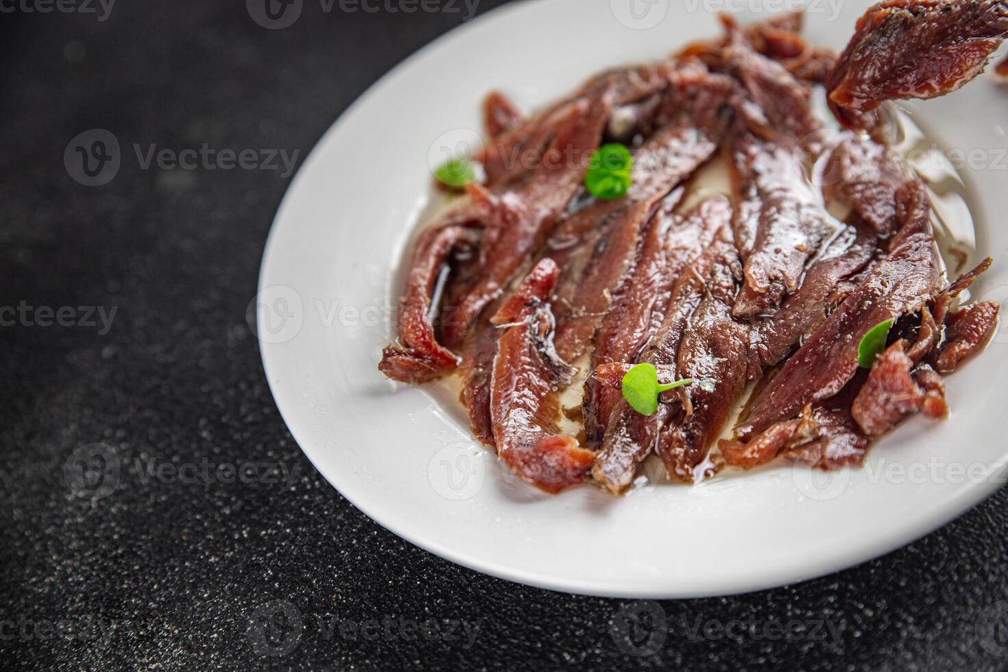 anchovies in a plate on the table canned fish in oil fresh and tasty seafood meal food snack on the table copy space food background rustic photo