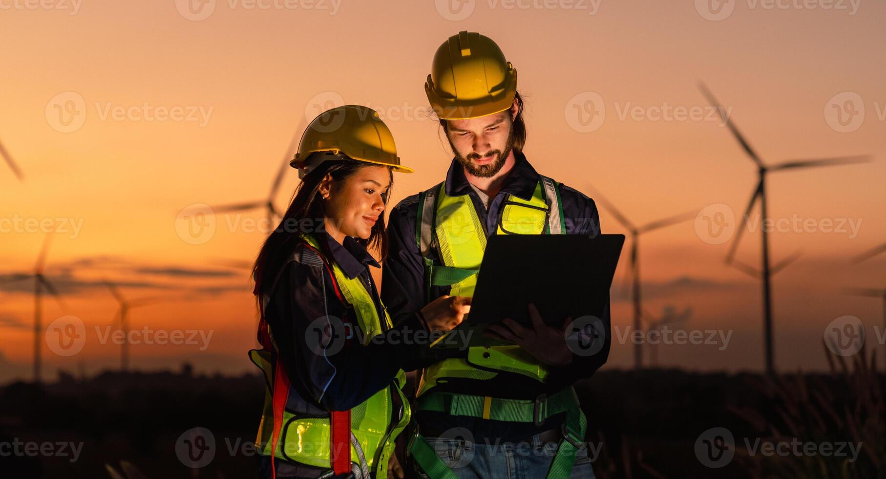 Engineer and energy farming. windmills with the silhouette of a sunset background. photo