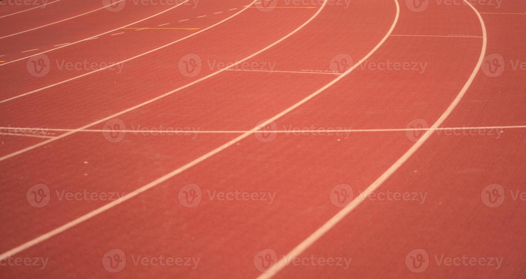 Red running track lines in the stadium. photo